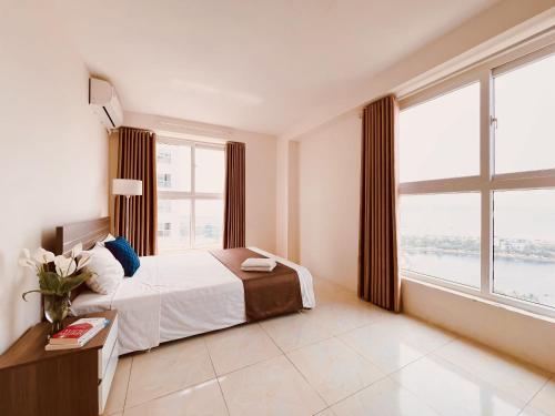 a bedroom with a bed and a large window at Hải Đăng Homestay - Hạ Long in Ha Long