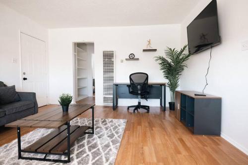 a living room with a desk and a chair at ModernHaven -SoFi, Forum, Intuit in Hawthorne
