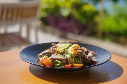 a blue plate of food on a table at Iririki Island Resort & Spa in Port Vila