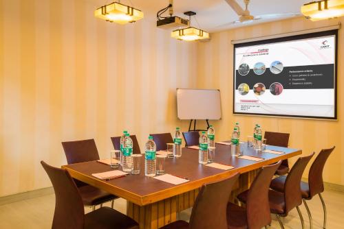 a conference room with a table with bottles of water at Home@F37 Kailash Colony Metro in New Delhi