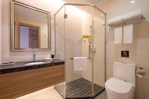 a bathroom with a shower and a toilet and a sink at Platinum Times Aparthotel in Shenzhen