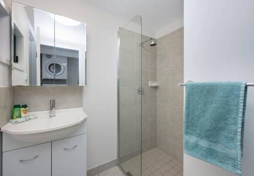 a bathroom with a sink and a shower at Stunning 2BR Beachfront Retreat in North Ward