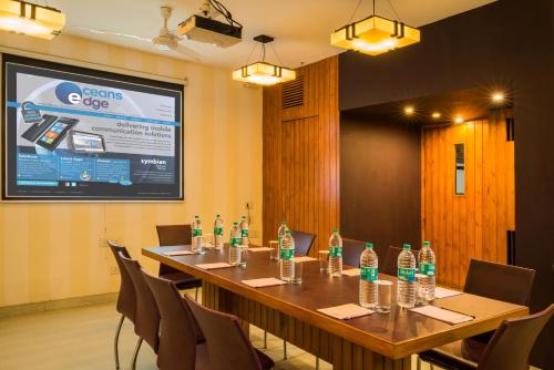 a conference room with a long table with bottles of water at Home@F37 Kailash Colony Metro in New Delhi