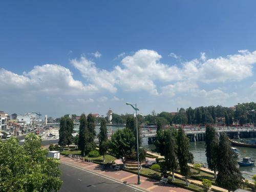 a city with a river and a street with trees at KimMy Home in Phan Thiet