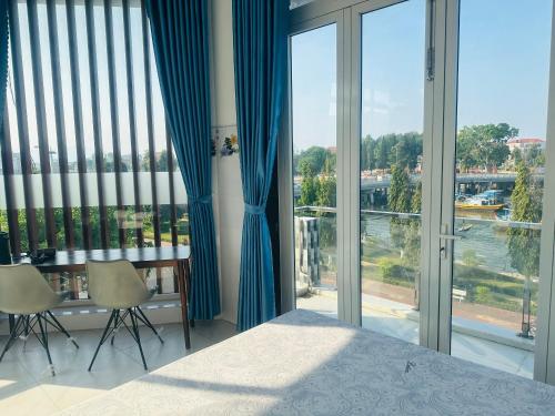 a bedroom with a bed and a large window at KimMy Home in Phan Thiet