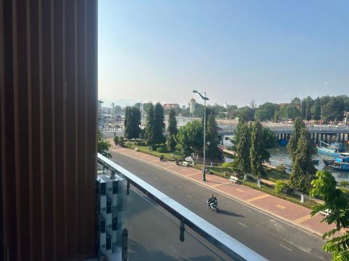 a person riding a motorcycle on a city street at KimMy Home in Phan Thiet