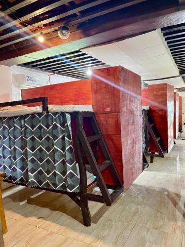 a row of wooden tables in a room at Fumiko Rina Acop in San Juan
