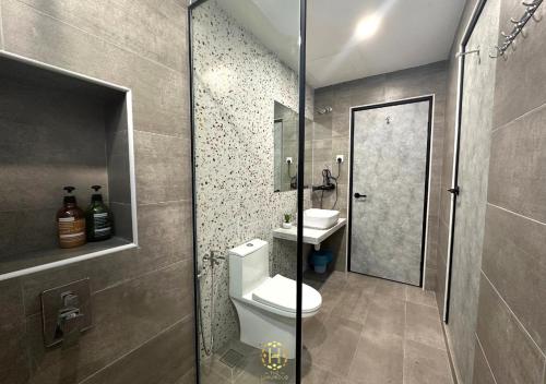 a bathroom with a toilet and a sink and a shower at The Luxurious 27, Johor Bahru in Johor Bahru