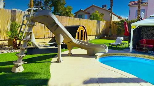 a slide in a yard next to a pool at Buddha Play Modern with Pool & Spa Sauna Near Vegas strip in Las Vegas