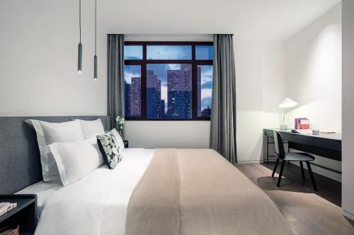 Llit o llits en una habitació de base-PUSAN Serviced Apartment