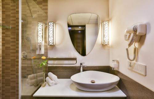 a bathroom with a sink and a mirror at T24 Residency in Mumbai