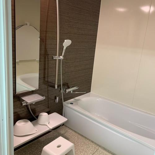 a bathroom with a tub and a toilet and a sink at seaside villa HILIFE - Vacation STAY 27367v in Kogushi