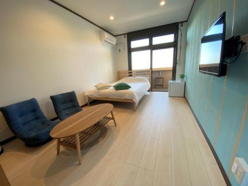 a room with a bed and a table and chairs at seaside villa HILIFE - Vacation STAY 99007 in Kogushi