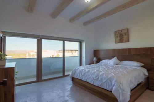 a bedroom with a bed and a large window at Villa Parvada 6 in Parras de la Fuente