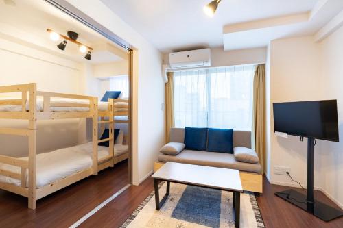 a living room with a couch and bunk beds at Art Nagara in Osaka