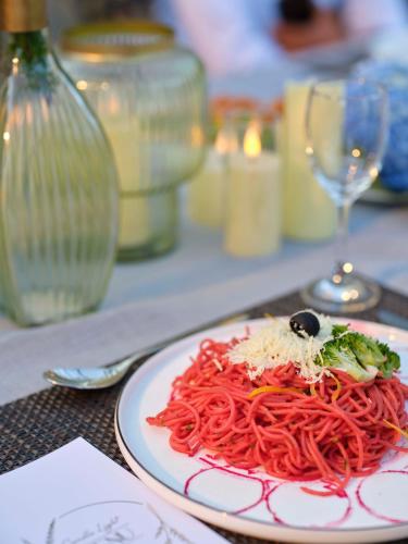 a plate of spaghetti with a black olive on top at Blanket Days Resort and Spa in Thekkady
