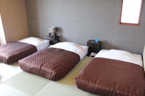 Tempat tidur dalam kamar di Hotel Shiosai
