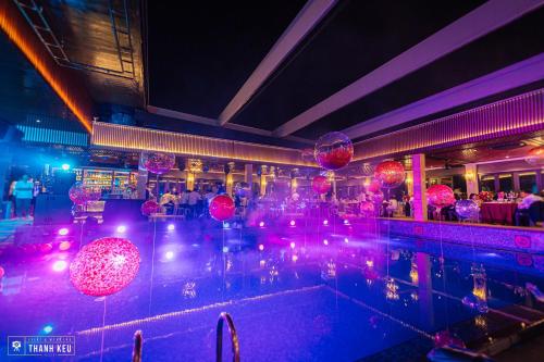 a room with a pool with red balls and lights at Apricot Hotel in Hanoi