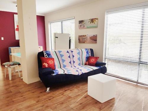 a living room with a couch and a table at Dolphin Beach House - Wannanup, Mandurah between the estuary and the ocean in Wannanup