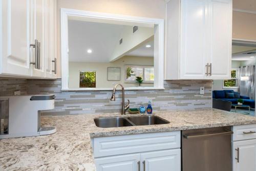 a kitchen with white cabinets and a sink at Luxury 3BR House w/ Jacuzzi & Big Backyard! in Los Angeles