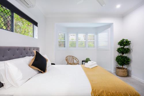 a bedroom with a large white bed with a window at 5 Star Villa in Tropical location with Patio and Hot Tub 3 bedroom 2 Bath in Edge Hill