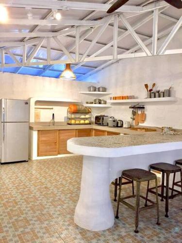 a kitchen with a large white island in a room at Villa Ameda Homestay @ Sg Sembilang in Jeram
