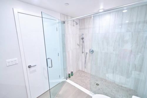 a bathroom with a shower with a glass door at Luxury at its Finest in Larchmont W. Roof Deck in Los Angeles