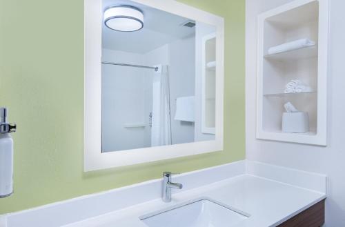 a bathroom with a sink and a mirror at Holiday Inn Express Hotel & Suites Birmingham - Inverness 280 by IHG in Birmingham