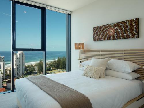 a bedroom with a large bed with a view of the ocean at The Gallery Residences Broadbeach - Official Listing in Gold Coast