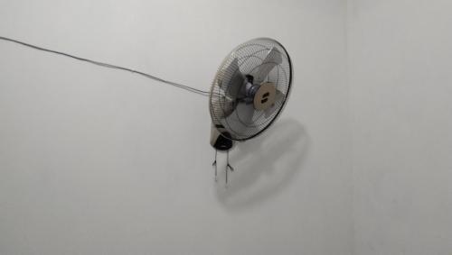 a white fan sitting on top of a wall at Home stay & Kost syariah SONY CA E.15 in Batu Hampar