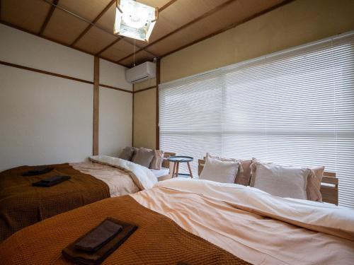 Voodi või voodid majutusasutuse -大垣 椛-古民家の宿大垣城まで車で10分 toas