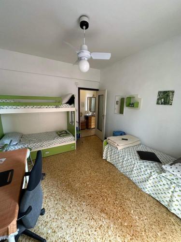 a room with two bunk beds and a desk at Vicino al mare in Borgio Verezzi