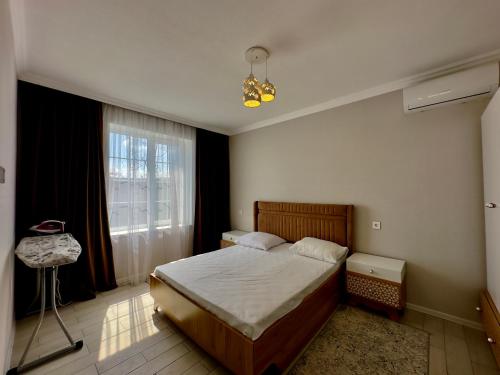 a bedroom with a bed and a window at Gabala Modern Harmony in Gabala