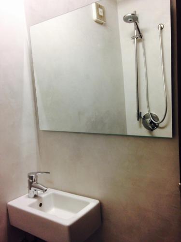 a bathroom with a sink and a mirror at Como Studio Flat in Como