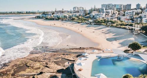 an aerial view of a beach and the ocean at Bright Stylish Kings Beach Apartment in Caloundra