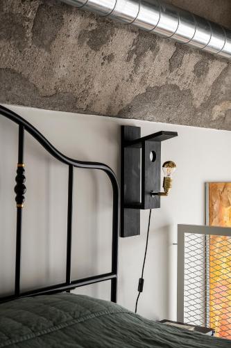 a bedroom with a bed and a concrete wall at Super stylish loft in Tallinn
