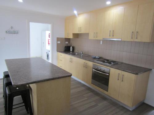 a kitchen with wooden cabinets and a counter top at Retreat on Talbot in Port Vincent