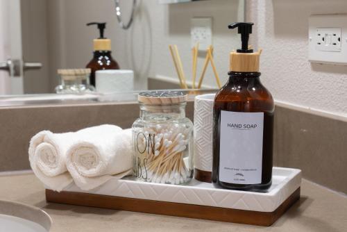 a bathroom sink with a bottle of mouth soap and towels at Charming Luxury Apartment with Hollywood Sign View in Los Angeles