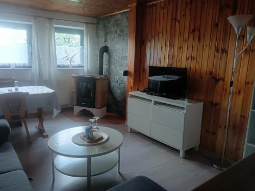 Jindřichovice的住宿－U krbu，带电视的客厅和带桌子的客厅。