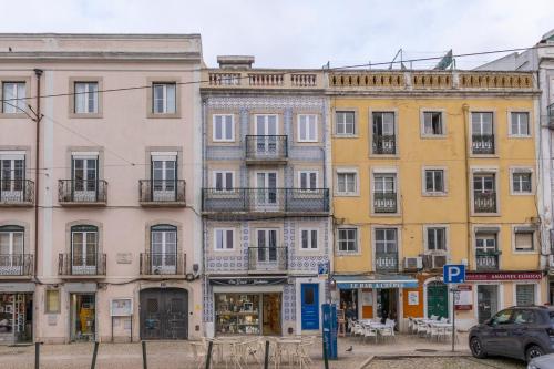 a row of buildings on a city street at Graça Square Heritage Apartments by Tram 28 by NestAtLisbon in Lisbon