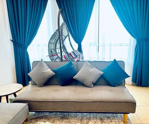 a couch with blue pillows in a living room at lagoon view-Entire apartment in Sharjah