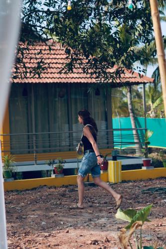 a woman walking in front of a building at Vrindavan homestay in Munroe Island