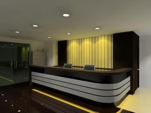a lobby with a waiting area with blue chairs at Syaz Meridien Hotel in Melaka