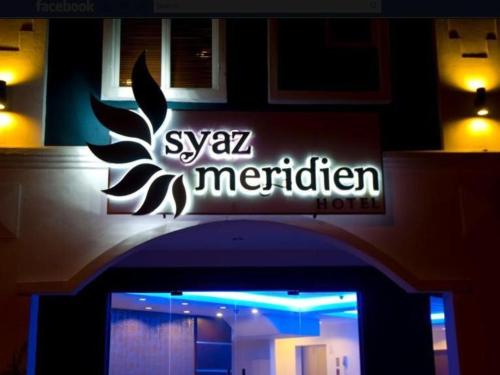a sign on the front of a building at Syaz Meridien Hotel in Melaka