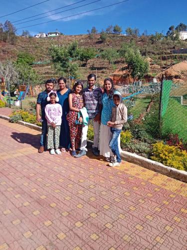 a group of people posing for a picture at Private 3BHK Villa with a Parking, Garden, WiFi, Mountain View in Kodaikānāl