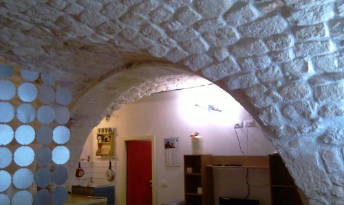 a room with a stone wall and an archway at Dammuso Raffaello in Scicli