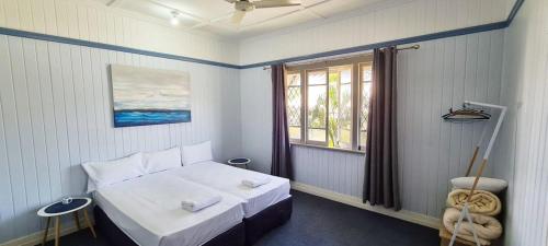 a small bedroom with a bed and a window at Park View Self-Contained in Bundaberg