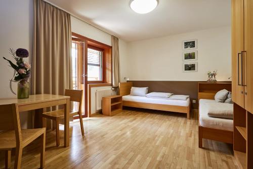 a living room with a bed and a table at FAST Ossiach in Ossiach