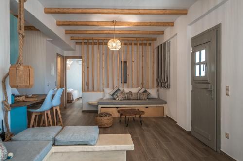 a living room with a bed and a table at Epithea Suites Kythnos 4 με ιδιωτική πισίνα in Kithnos