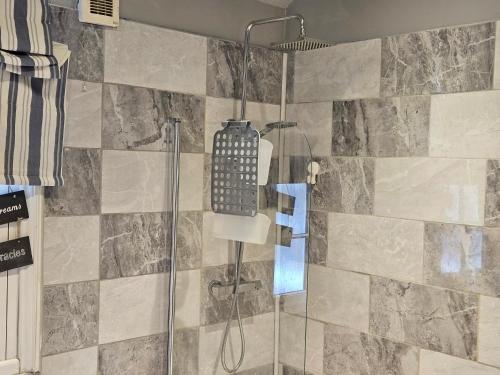 a bathroom with a shower with a glass door at Prime Location Room Stay in Northampton